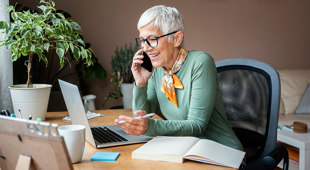 Person taking a phone call in their office.